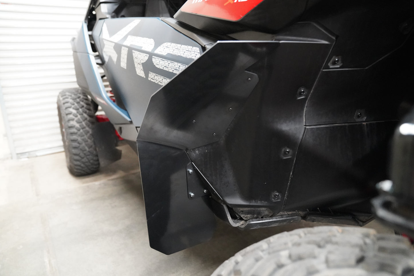 Detail shot of Factory UTV precision-bent ABS fender flare fitment on Maverick R