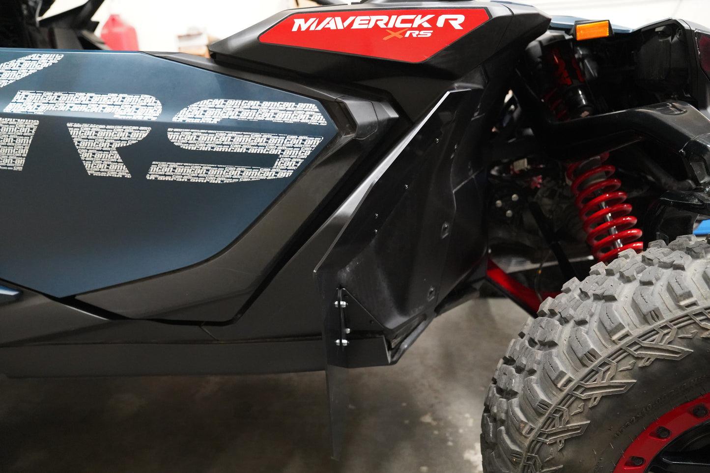 Side angle view of Factory UTV front fender flares installed on a Can-Am Maverick R, showing rugged off-road protection.