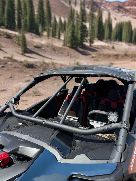 ATV with a roll cage in a mountainous outdoor setting