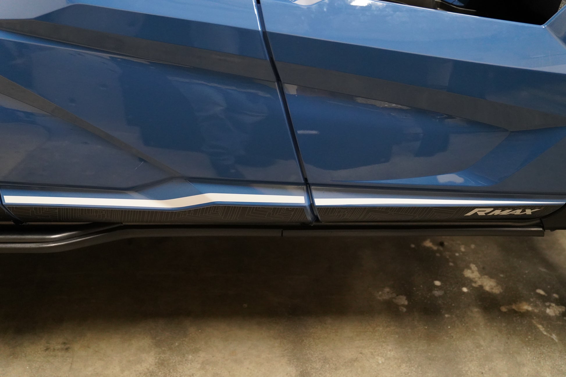 UHMW rock sliders protecting the side rocker panels of a 2025+ Yamaha Wolverine RMAX4.