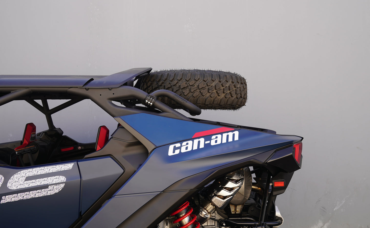Can-Am vehicle with a spare tire mounted on a plain background