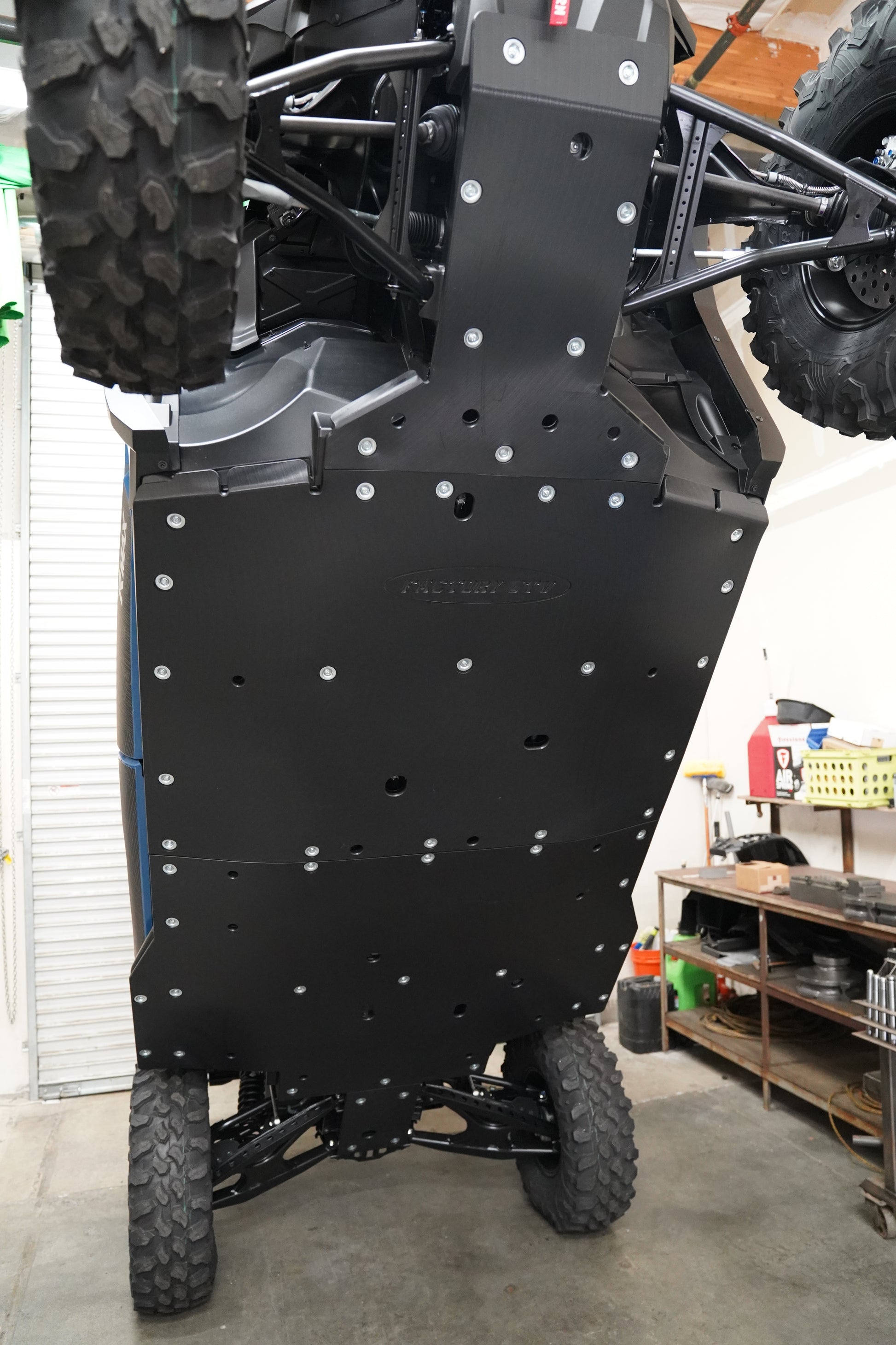 Side angle view of UHMW skid plate installed on Yamaha RMAX4